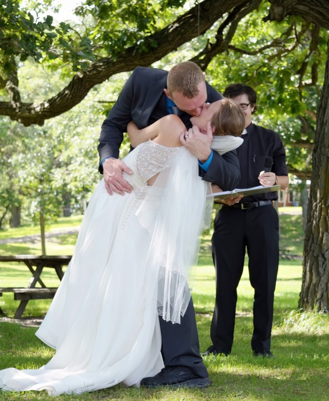 Groom Kissing Bride by Lance Albers