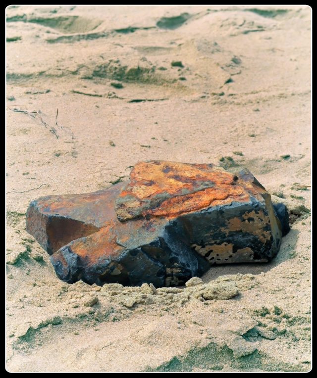Rock on a beach by Lance Albers Photographer
