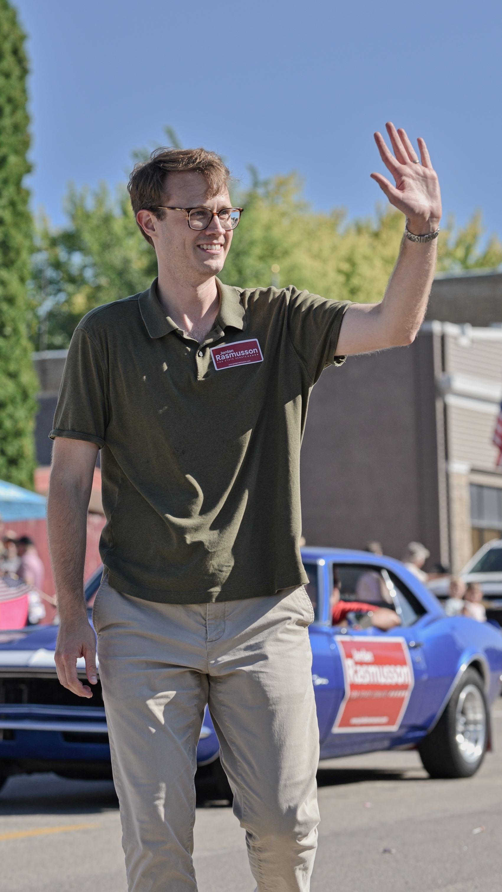 Jordan Rasmusson waving to the crowd while walking in the 2026 Underwood Harvest Festival Parade.