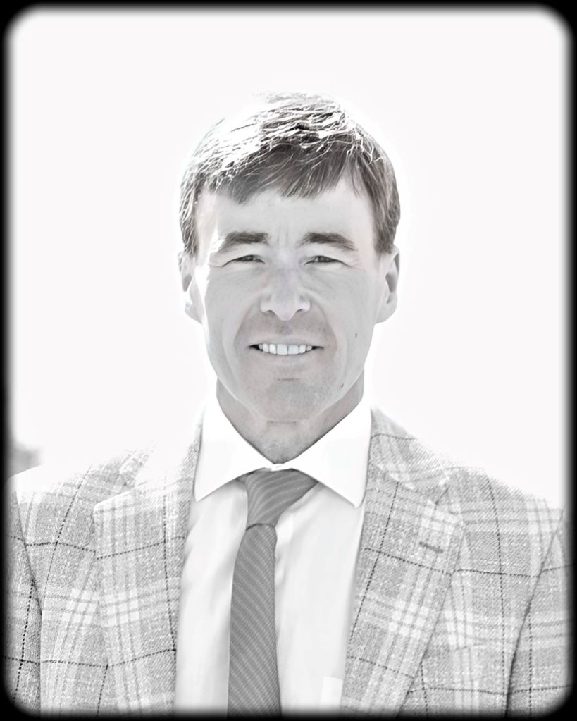 Former Fergus Falls Mayor Ben Schierer, current Minnesota Lieutenant Governor candidate, smiling in a plaid suit and tie.