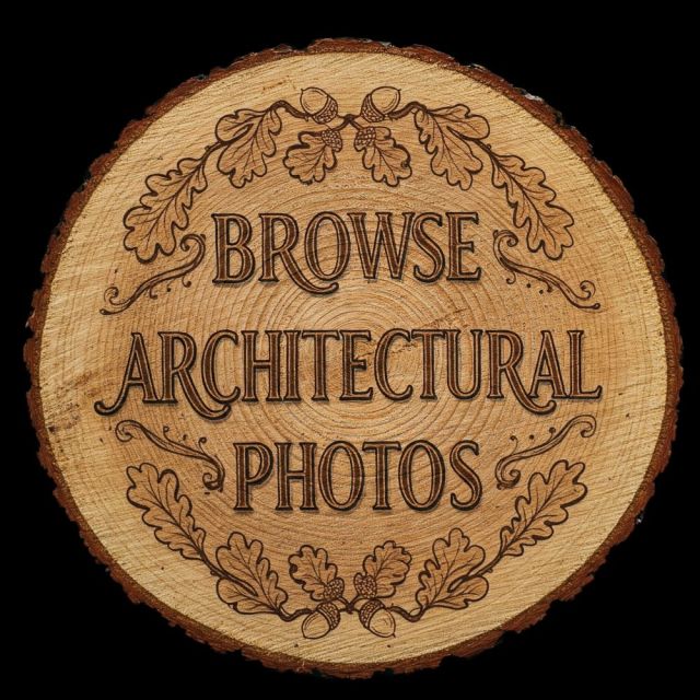 Round wood slice engraving with the text "Browse Architectural Photos" framed by an ornate oak leaf and acorn border, linking to a professional architectural photography portfolio.