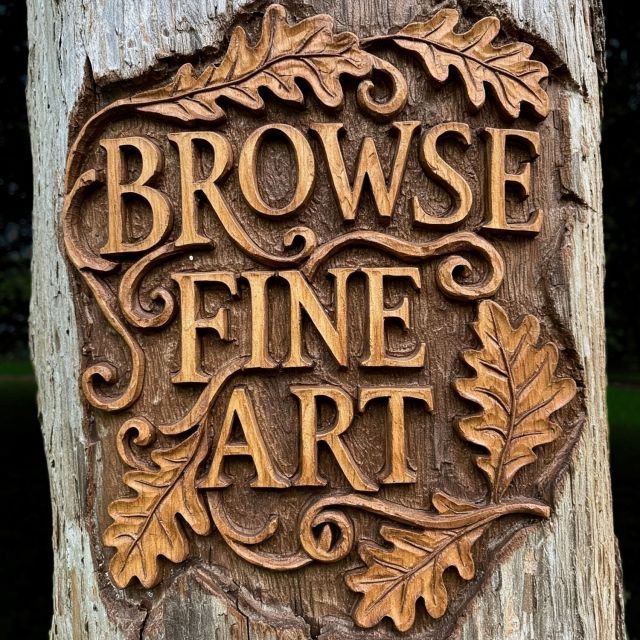 An intricate wooden sign carved directly into a tree trunk, with deep-grained oak leaves framing the raised text "BROWSE FINE ART" on lancealbers.com website.