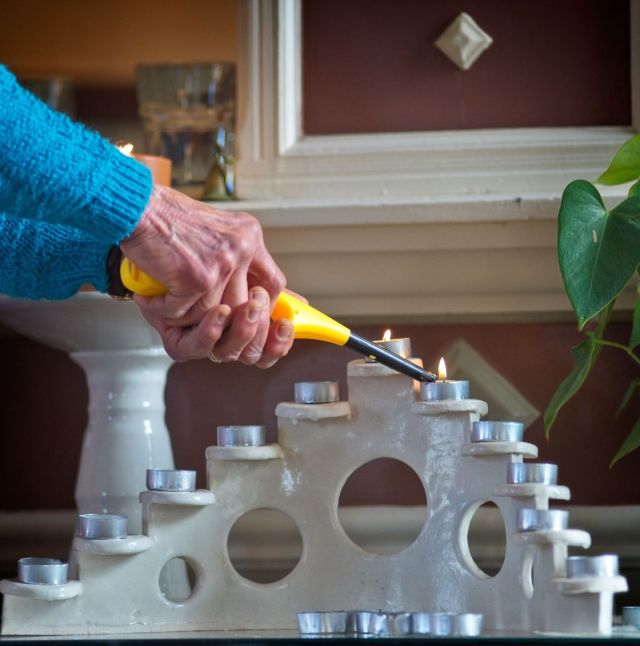 A person lighting tealight candles during a "Candles of Joy and Concern" service at the Unitarian Universalist Church in Underwood, Minnesota.