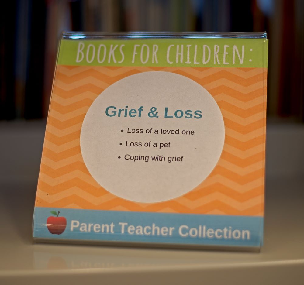 A library display sign for children's books regarding grief and loss from the Parent Teacher Collection.