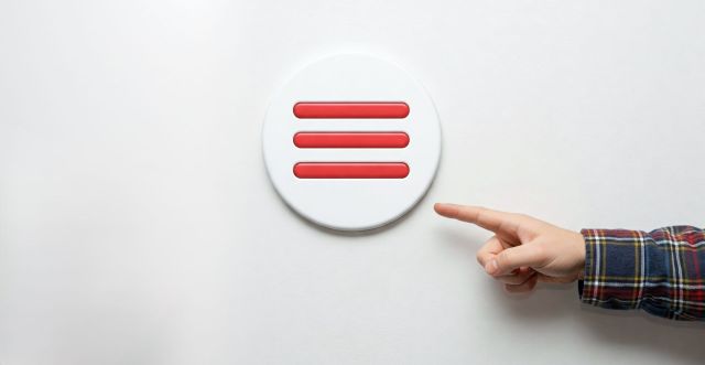 A person's hand in a plaid shirt pointing at a white circular button containing three horizontal red lines, illustrating how to open a mobile website navigation menu.