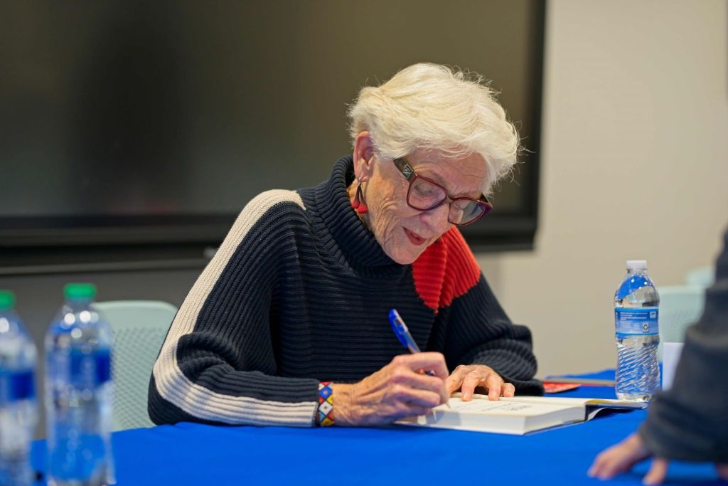 Former Minnesota Lieutenant Governor Marlene Johnson signing copies of her memoir, Rise to the Challenge, at a book tour event.