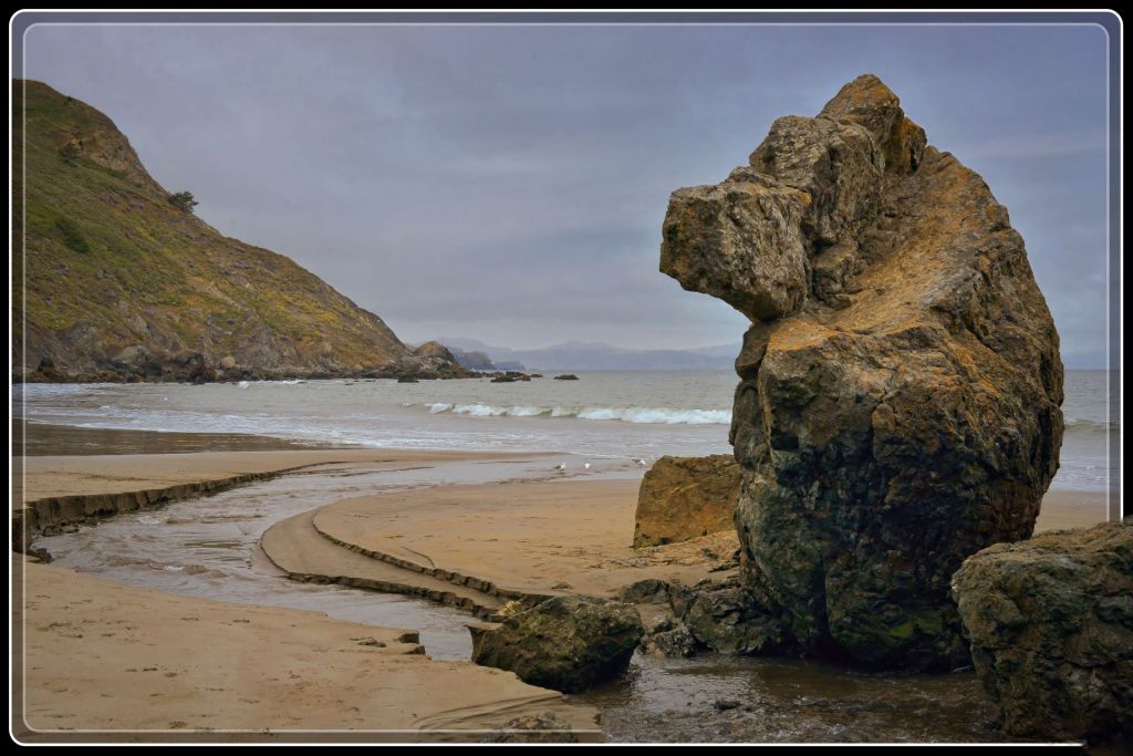 Bear shaped rock on the beautiful shore of Muir Beach, CA on a chilly and windy day.