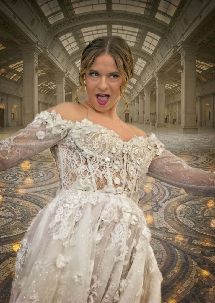 A bride model making a funny, expressive face in an ornate lace wedding dress inside a grand, historic hall with mosaic tile flooring and vaulted ceilings.